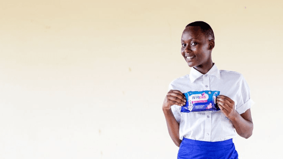 a girl holding a reusable pad kit