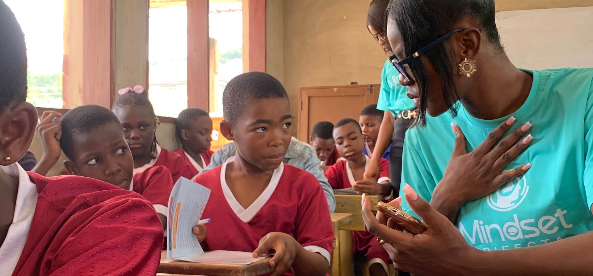 Sylvia Ademang guiding young people during a reflection session as part of community outreach initiative by Mindset Trifecta