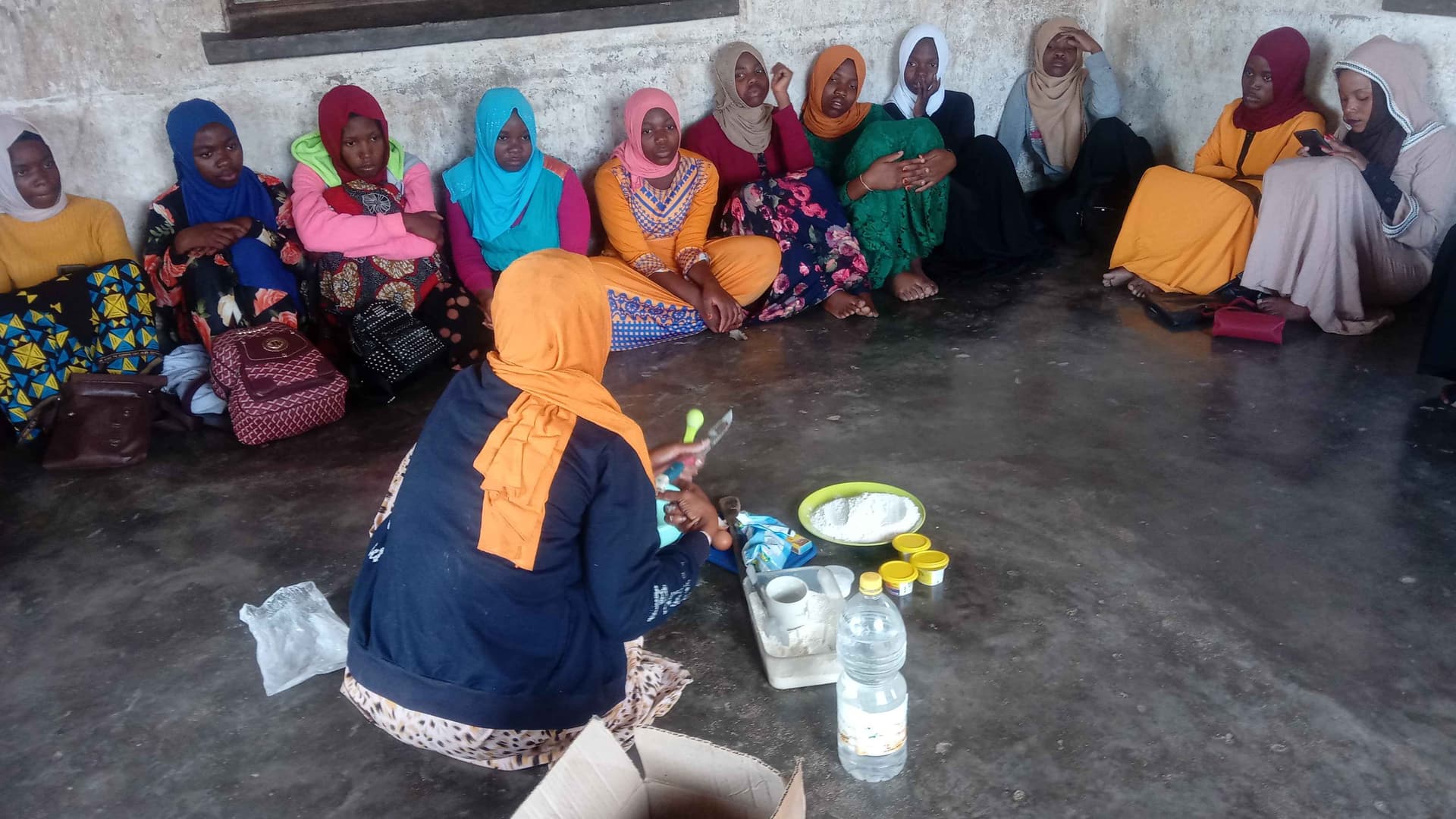 The girls were learning how to bake cake using charcoal